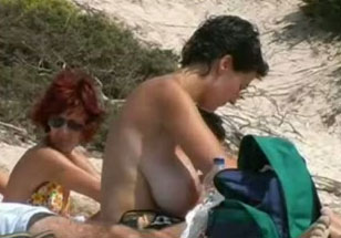 Hidden cam clip with a mom rubbing her big tits at a nude beach photo picture