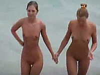 A couple of completely naked young sexy blondes on the beach