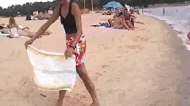 Mature brunette wife flashes her svelte body all naked on the nude beach