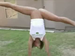 My sexy girlfriend does gymnastics half naked in the backyard