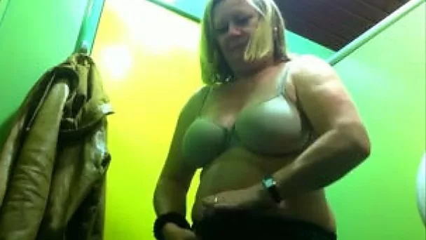 Chubby mature blondie changes her clothes in public locker room