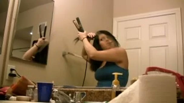 Hot and busty brunette babe in the bathroom brushing her hair