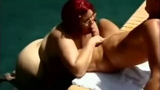 Redhead white mature fat lady by the pool is sucking cock