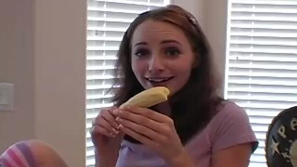 She eats banana and teases camera with gentle bites and licking