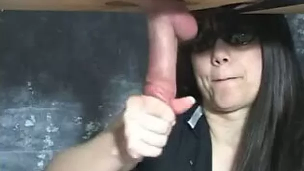 Wanking the dick of my husband through a hole on the table
