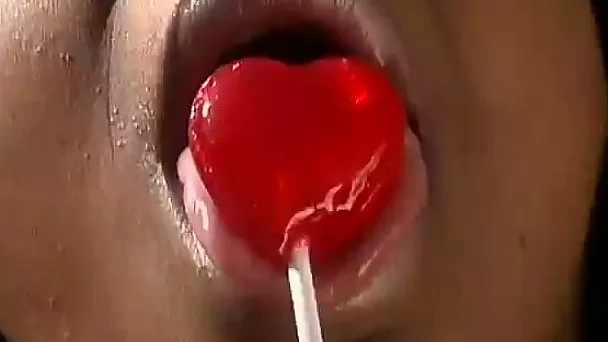 Ebony hussy sucks a lollipop outdoors and takes a ride on a BBC