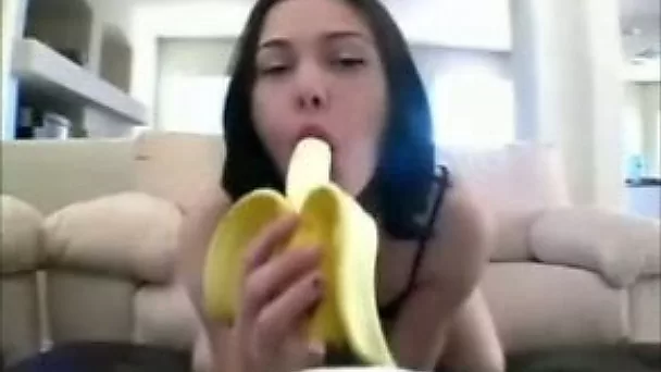 Beautiful and playful brunette girl is eating banana like a dick