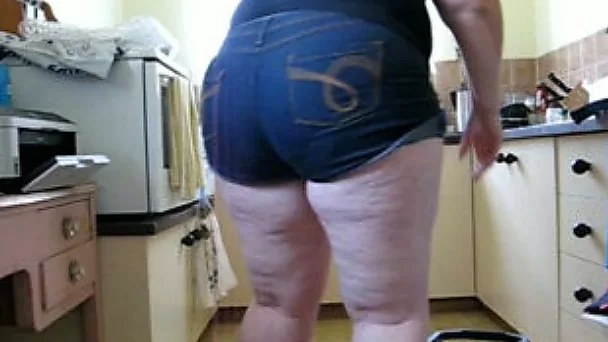 My chubby GF wearing shorts washes the floor and shows her big ass
