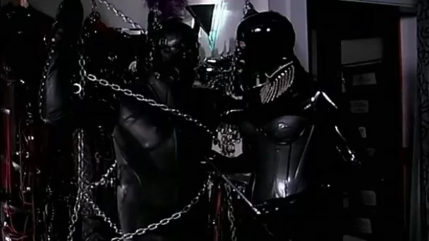 Male slave is chained and lets his mistress play with his cock