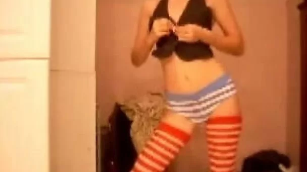 Slim girl stripping in front of a webcam isn't aware I am filming her