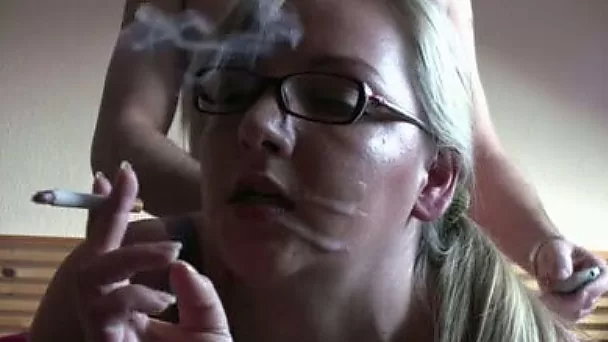 Amazing blonde smoking and fucking in her bedroom