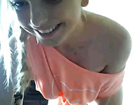 Pigtailed camgirl with tattoo on her back knows how to strip in a sexy way