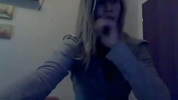 Slim amateur chick strips in front of a web camera