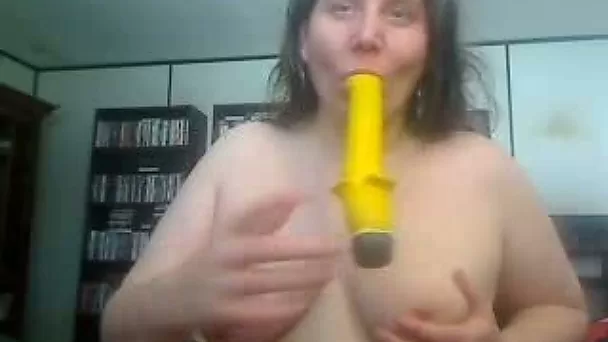 Extremly fat and playful mature lady playing with toy banana