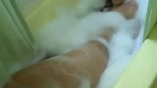 My wife fingers her soapy pussy while taking a bath