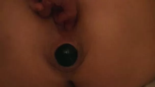 Big black ball in the butt hole of my babe peeping out