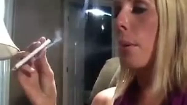 Hot blonde lady lights a cigarette and smokes so seductively