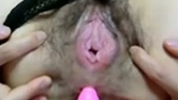 Big hairy pussy of Asian slut gets poked with a plastic dildo