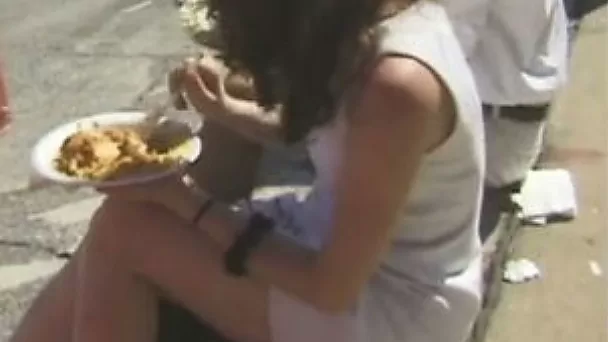 Vintage brunette milf is having a quick bite on the street