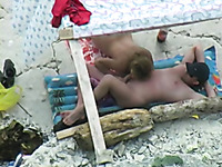 Amazing oral sex taped on the beach under the tent