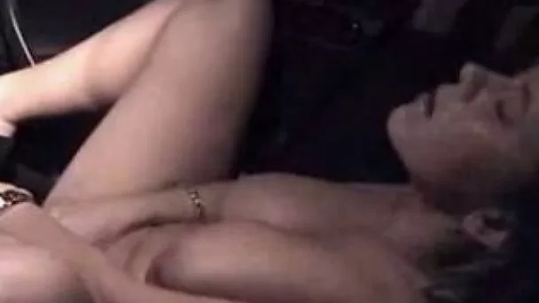 Big-breasted lady masturbates in a car in homemade solo clip