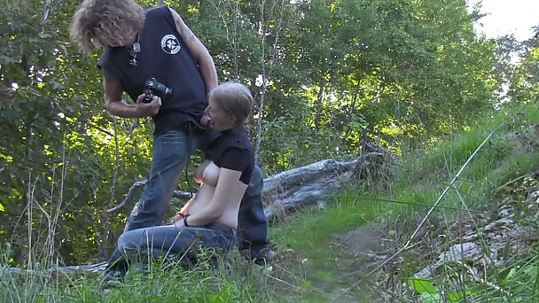 Busty amateur girl sucks and rubs a dude's dick in the forest
