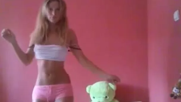 Petite blonde cutie in sexy pink panties dances in her bedroom