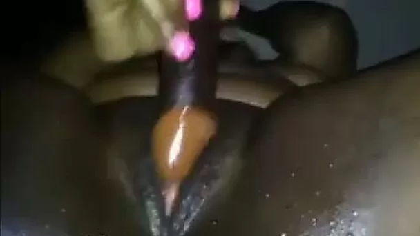Wet and fat black honeypot poked with a dildo for squirting