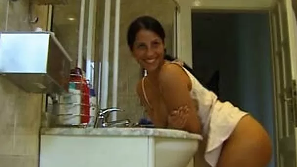 Awesome brunette chick masturbates her pussy in the bathroom