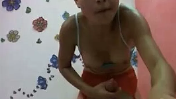 Petite Asian tranny jerks her big cock off in front of a webcam
