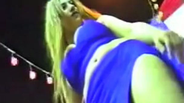 Busty Arab belly dancer in hot blue dress in the nightclub