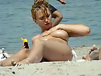 Hidden cam video with a well-endowed chick sunbathing topless