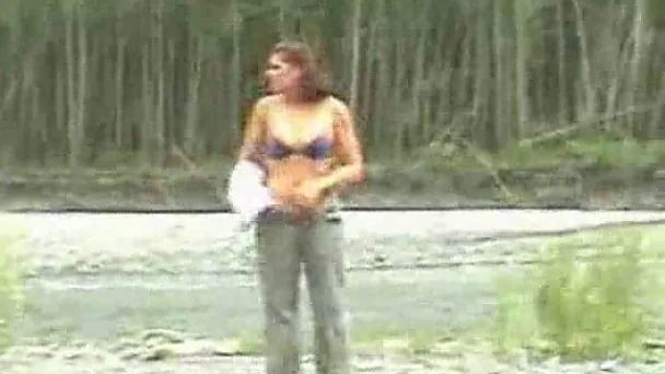 Curvaceous redhead girlfriend exposes her body over the river shore