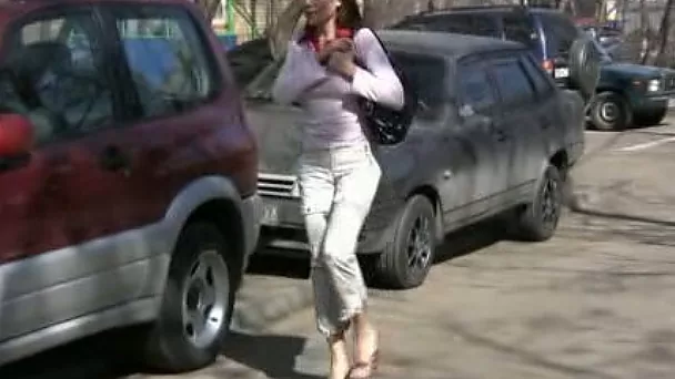 Russian brunette lady in the park makes her pants wet