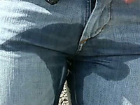 Her blue jeans are wet between her legs because she pissed in public