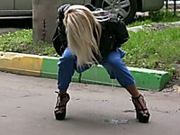 Blonde girl in Russia squats and pisses in her pants