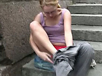 Here is a nerdy Russian blonde chick walking in the park and pissing