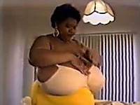 Horny ebony whore proudly flaunts her disproportionately large boobies