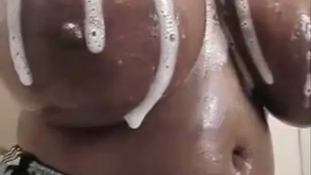 My ebony wife washes her enormous natural tits in the shower