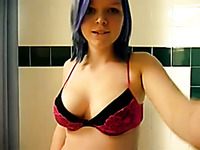 Nice blue haired teen with big tits is showering in front of me