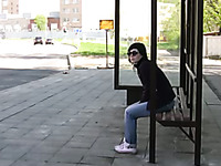 Brunette skank pees in her jeans at a busstop and enjoys herself