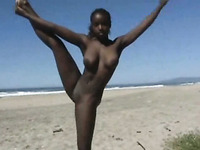 Busty ebony amateur hottie on the beach doing acrobatic tricks