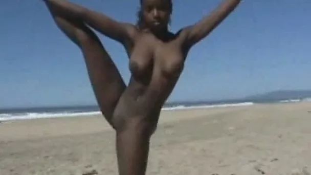 Busty ebony amateur hottie on the beach doing acrobatic tricks