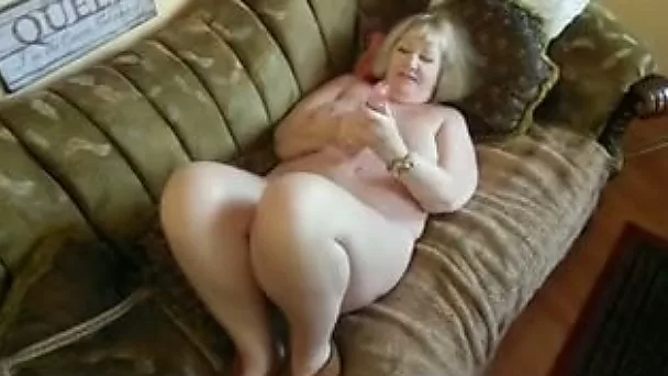 My mature fat spouse plays with her new dildo on the sofa