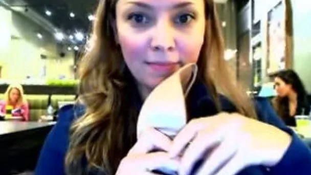 Charming chick takes her bra off in a public place