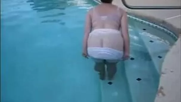 My elderly wife demonstrates her big boobs in the pool