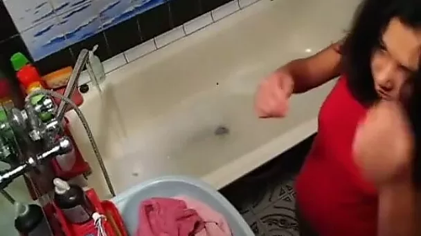 Tanned chick with small tits is masturbating in the bathtub