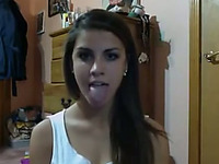 Hypnotically sexy teen is proudly showing off her long tongue