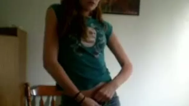 Slender teen strips and demonstrates her hairy pussy