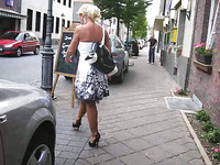 Torrid blonde wife walks on the street teasing with her stockings